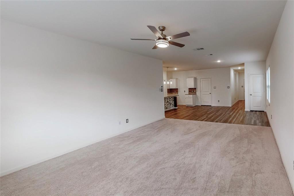 407 Madison Way Princeton, TX 75407 - Photo 14 of 40 Unfurnished living room with carpet floors, ceiling fan, recessed lighting, and wood finished floors