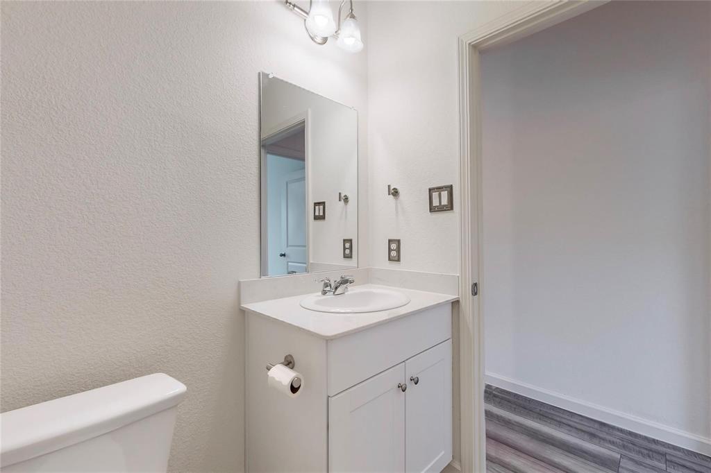 407 Madison Way Princeton, TX 75407 - Photo 17 of 40 Bathroom featuring vanity and wood finished floors