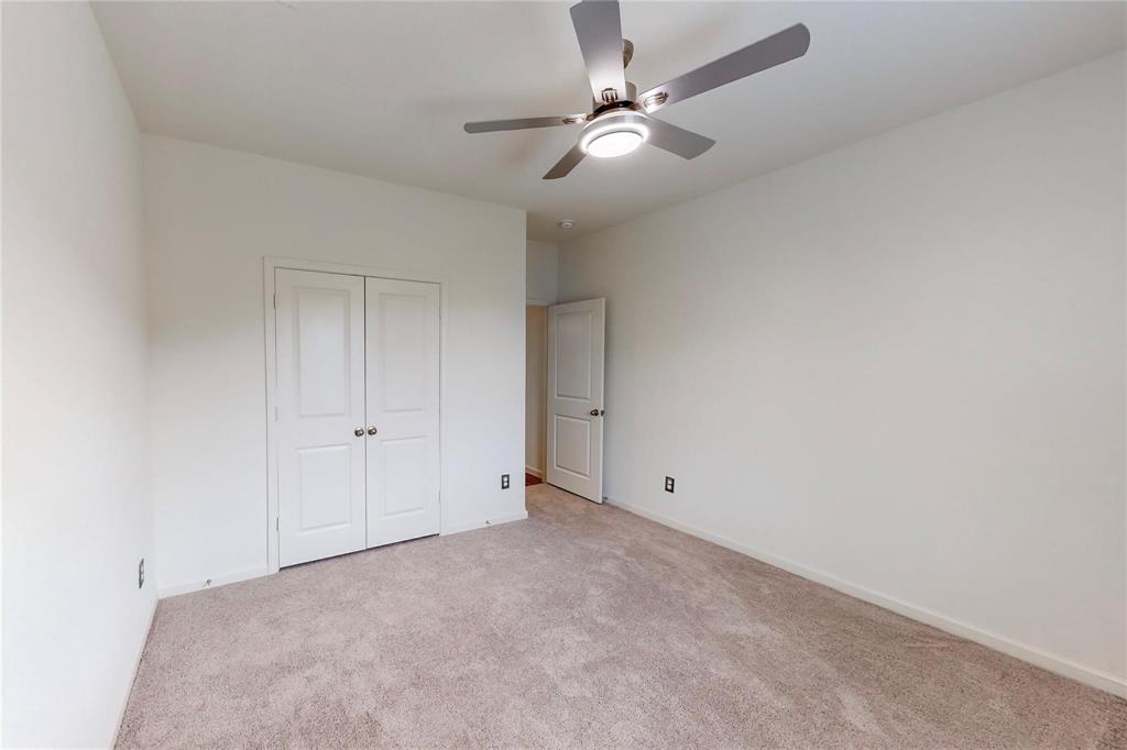 407 Madison Way Princeton, TX 75407 - Photo 18 of 40 Unfurnished bedroom with light carpet, a closet, and ceiling fan