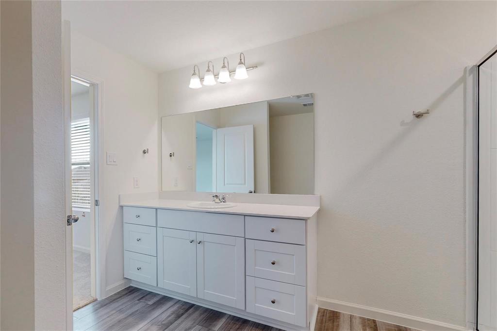 407 Madison Way Princeton, TX 75407 - Photo 27 of 40 Bathroom with wood finished floors, vanity, and a shower with door