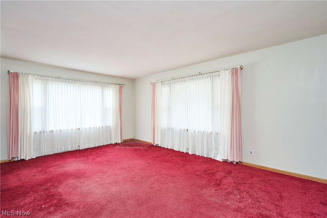 2941 Sweitzer Road Uniontown, OH 44685 - Photo 3 of 16 Carpeted spare room featuring baseboards