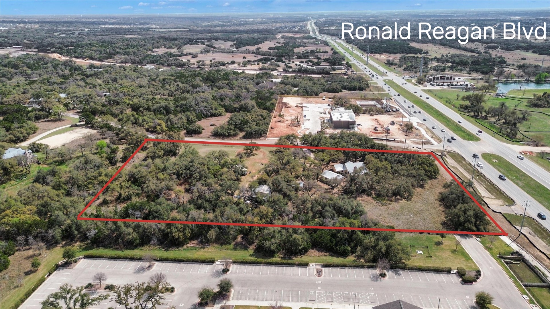 51 County Road 264 Leander, TX 78641 - Photo 2 of 17 Aerial view of property and surrounding area with property boundaries highlighted and a large body of water