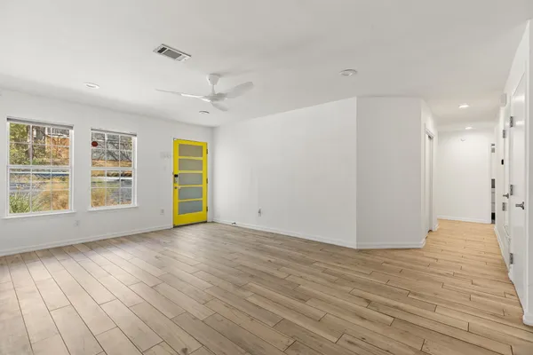 wooden floor in an empty room with a window