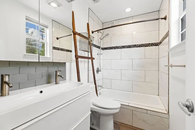a bathroom with a sink toilet and shower