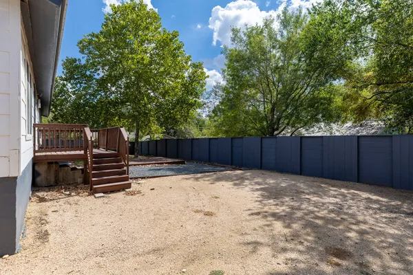 a wooden fence with trees in the background