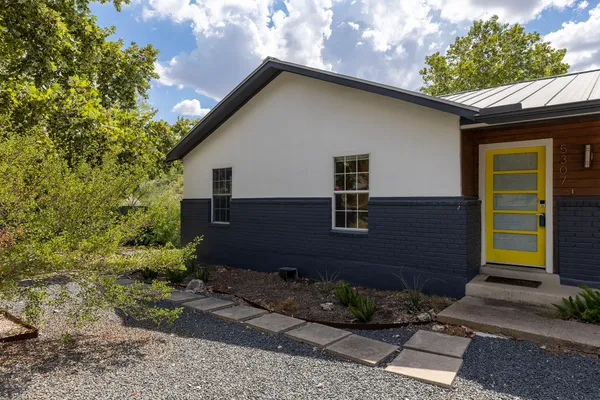 a front view of a house with garden