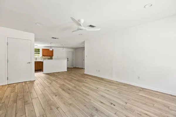 a view of empty room with wooden floor