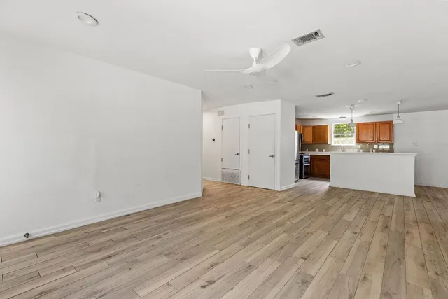a view of a kitchen with a sink and a refrigerator