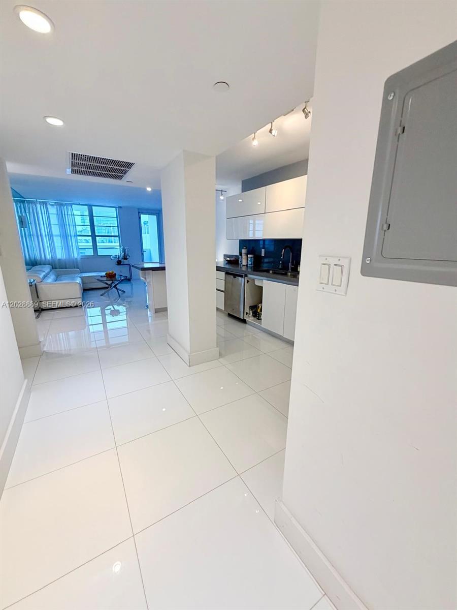 100 Lincoln Road, Unit 1504 Miami Beach, FL 33139 - Photo 14 of 17 a view of a kitchen with a sink and cabinets