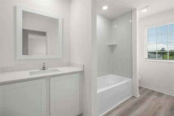 a bathroom with a bathtub and a sink