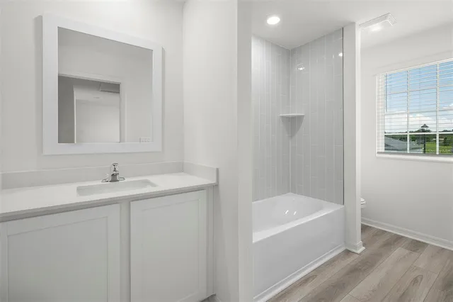 a bathroom with a bathtub and a sink