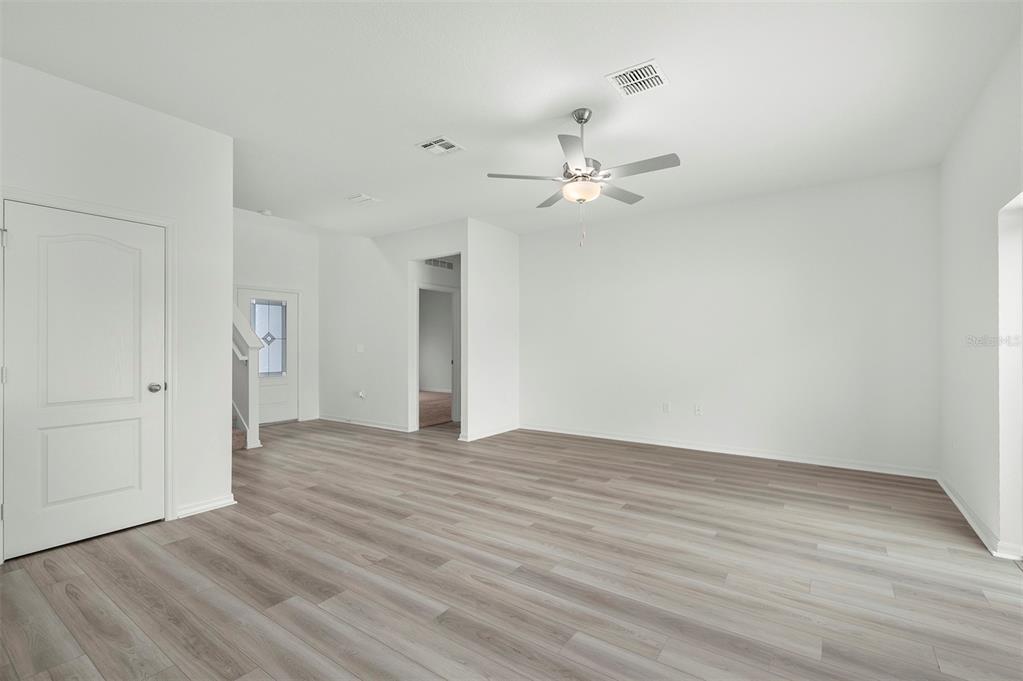 13320 Tula Loop Astatula, FL 34705 - Photo 7 of 22 a view of an empty room with wooden floor