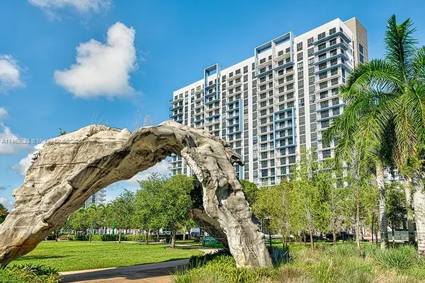 a view of a large building with a yard