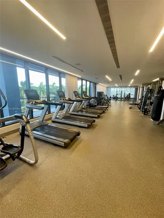 a living room with couches and kitchen view