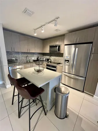 a kitchen with a sink a stove a microwave and cabinetry