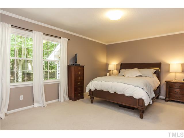 5609 Knollwood Road Raleigh, NC 27609 - Photo 14 of 25 a bedroom with a bed and a large window