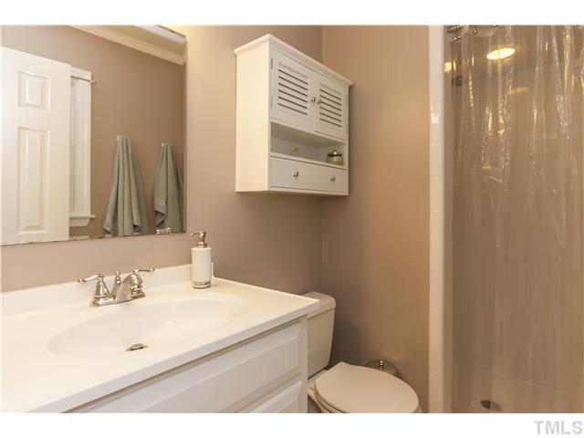 5609 Knollwood Road Raleigh, NC 27609 - Photo 15 of 25 a bathroom with a sink mirror and a toilet