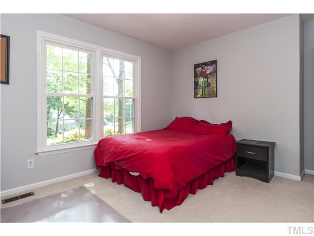 5609 Knollwood Road Raleigh, NC 27609 - Photo 17 of 25 a bed sitting in a bedroom next to a window