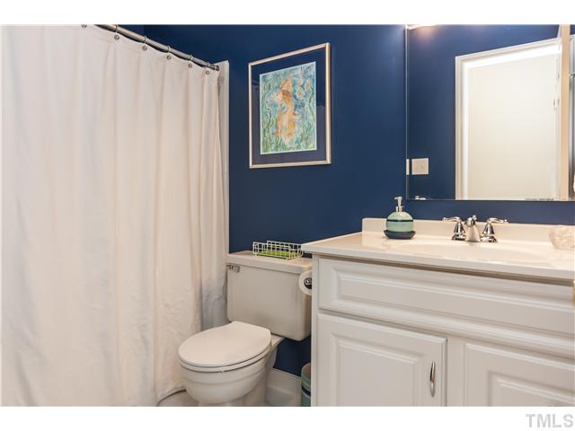 5609 Knollwood Road Raleigh, NC 27609 - Photo 18 of 25 a bathroom with a sink a toilet and mirror