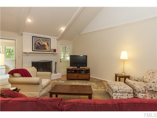 5609 Knollwood Road Raleigh, NC 27609 - Photo 5 of 25 a living room with furniture and a fireplace