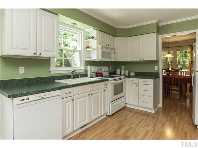 5609 Knollwood Road Raleigh, NC 27609 - Photo 8 of 25 a kitchen with granite countertop white cabinets white appliances and sink