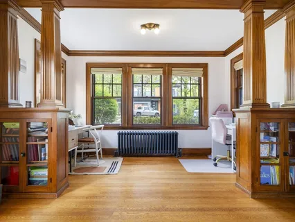 a bedroom with furniture and a large window