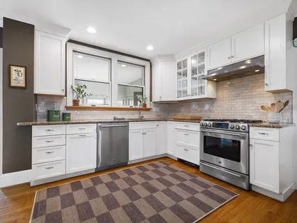 a kitchen with a stove oven and sink