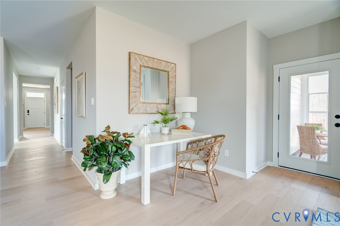 16000 Canoe Pointe Loop, Unit 164 Moseley, VA 23120 - Photo 12 of 29 a view of a hallway with wooden floor and a potted plant
