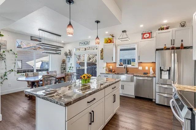 a kitchen with refrigerator and cabinets