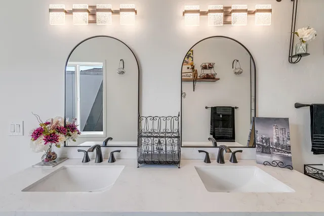 a bathroom with double vanity sink and a mirror