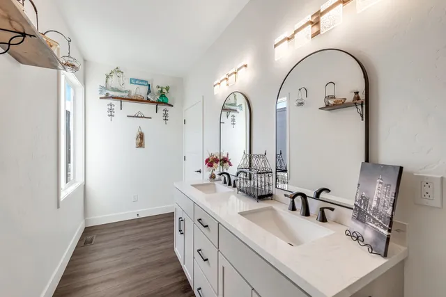 a bathroom with a double vanity sink and mirror
