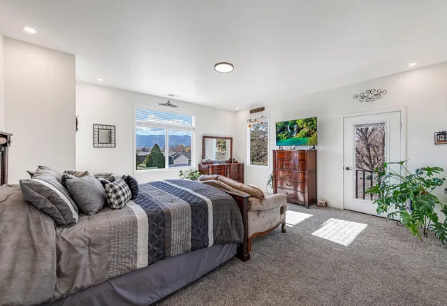 a bedroom with bed and a window