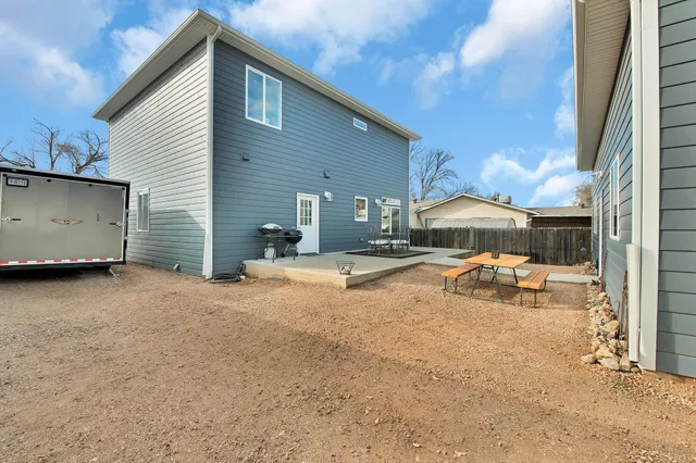 a swimming pool with outdoor seating and yard