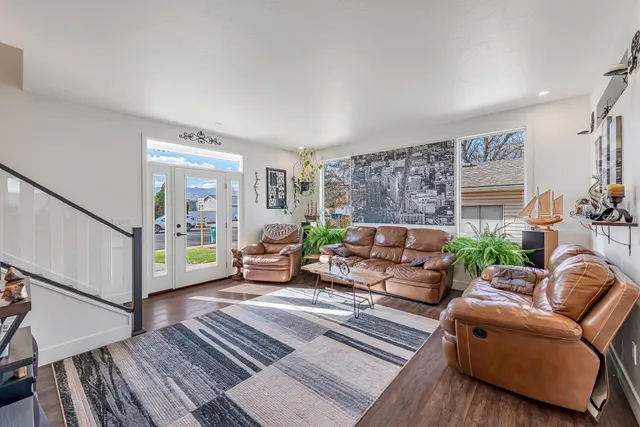 a living room with furniture and a wooden floor