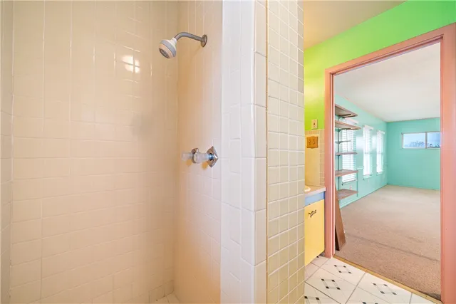 a backyard of a house with table and chairs and potted plants