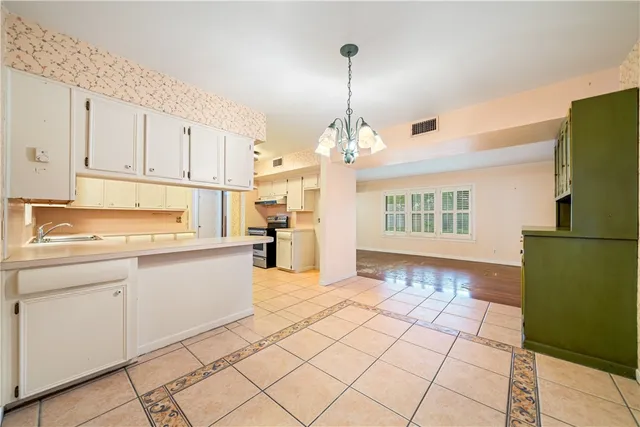 a kitchen with a stove top oven and cabinets