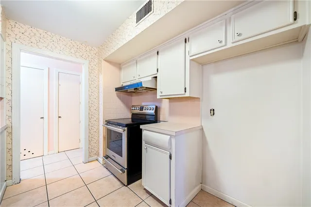 a kitchen with cabinets and white appliances