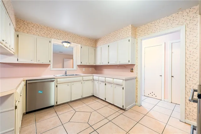 a kitchen with cabinets and appliances