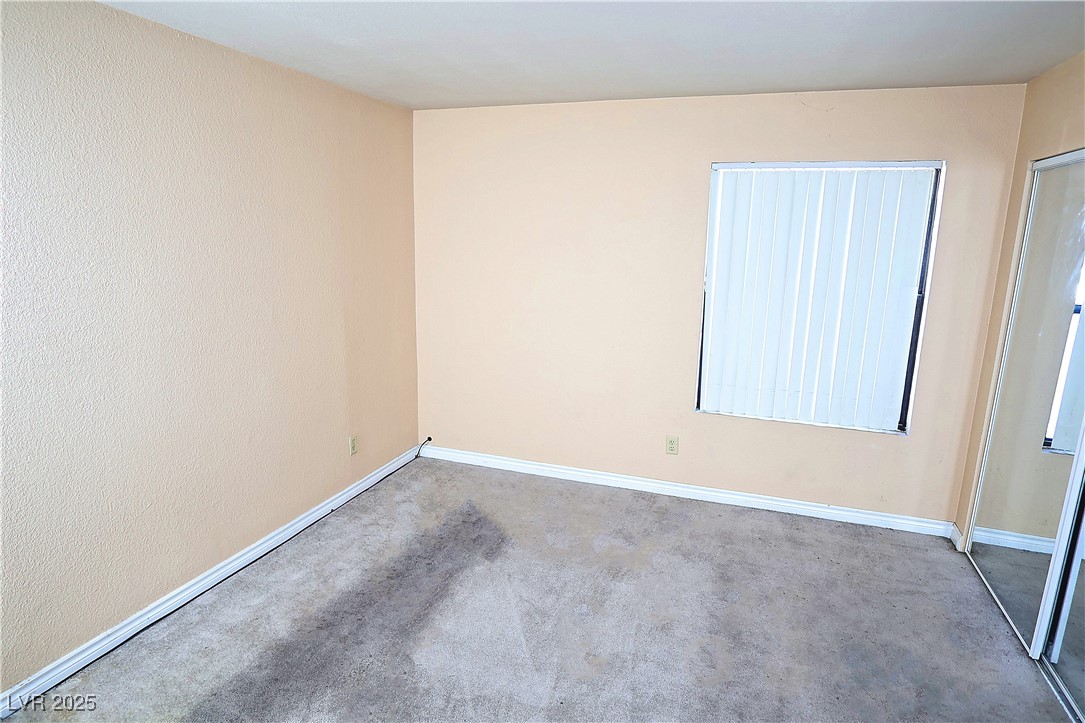 2451 North Rainbow Boulevard, Unit 1020 Las Vegas, NV 89108 - Photo 12 of 14 Spare room featuring carpet floors and baseboards