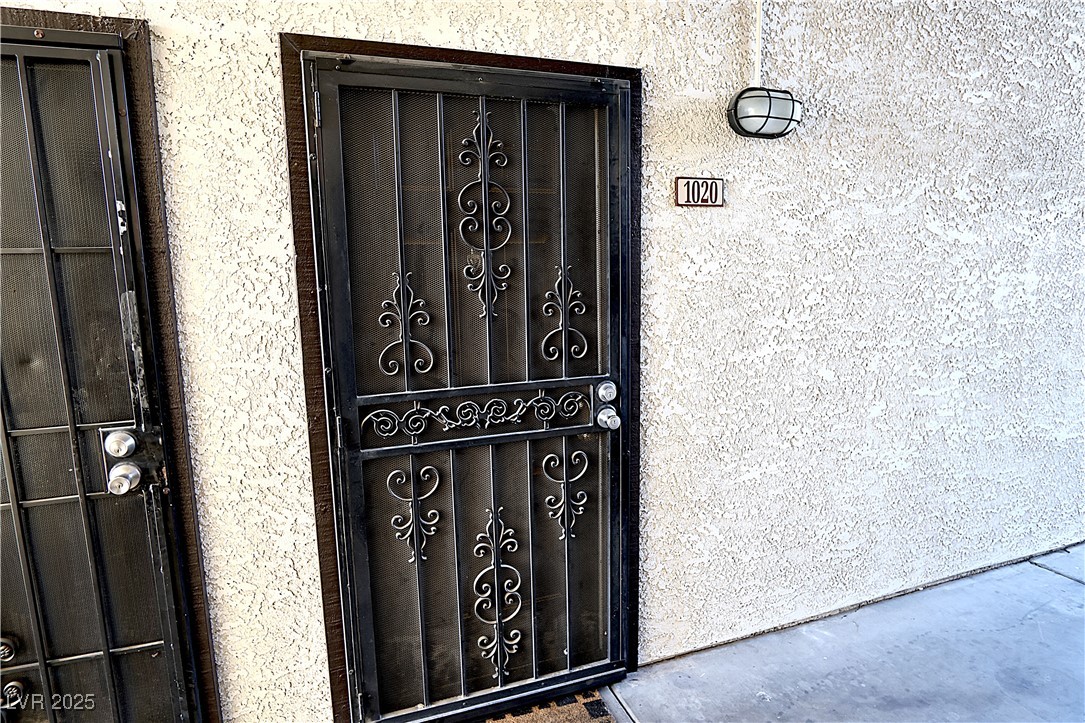 2451 North Rainbow Boulevard, Unit 1020 Las Vegas, NV 89108 - Photo 4 of 14 Doorway to property featuring stucco siding