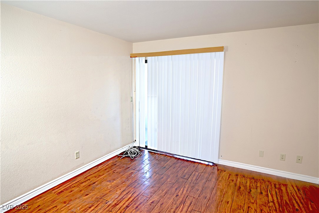 2451 North Rainbow Boulevard, Unit 1020 Las Vegas, NV 89108 - Photo 6 of 14 Spare room with dark wood-style flooring and baseboards