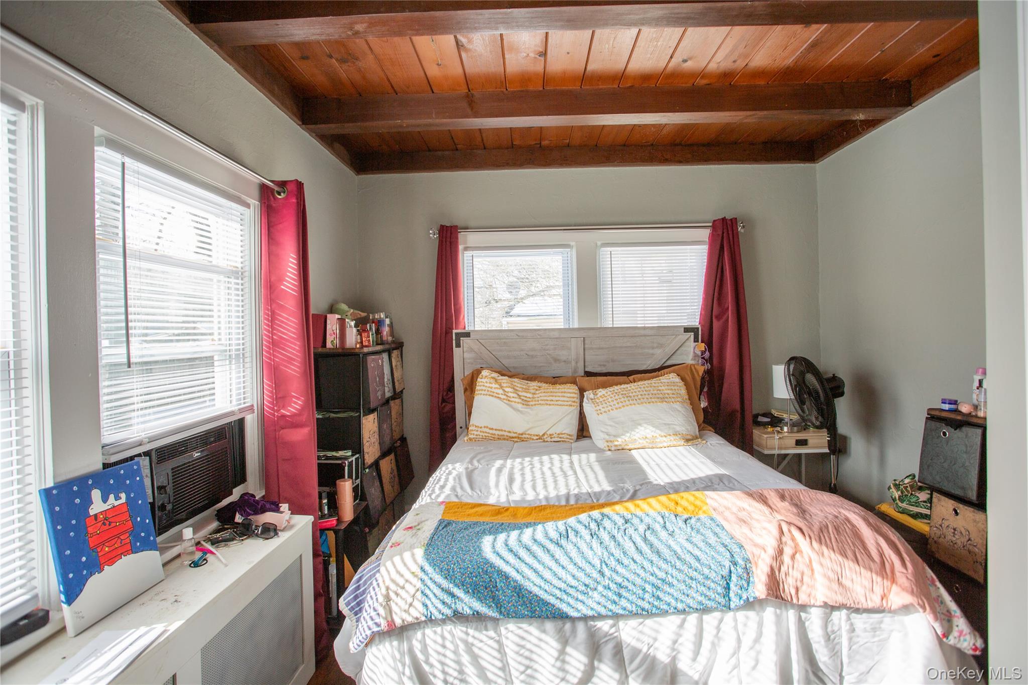 261 Rutland Road Freeport, NY 11520 - Photo 12 of 15 a bedroom with a bed and wooden floor