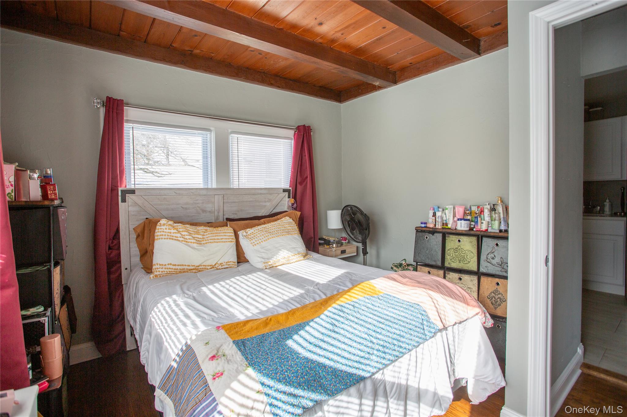 261 Rutland Road Freeport, NY 11520 - Photo 13 of 15 a bedroom with a bed and a wooden floor