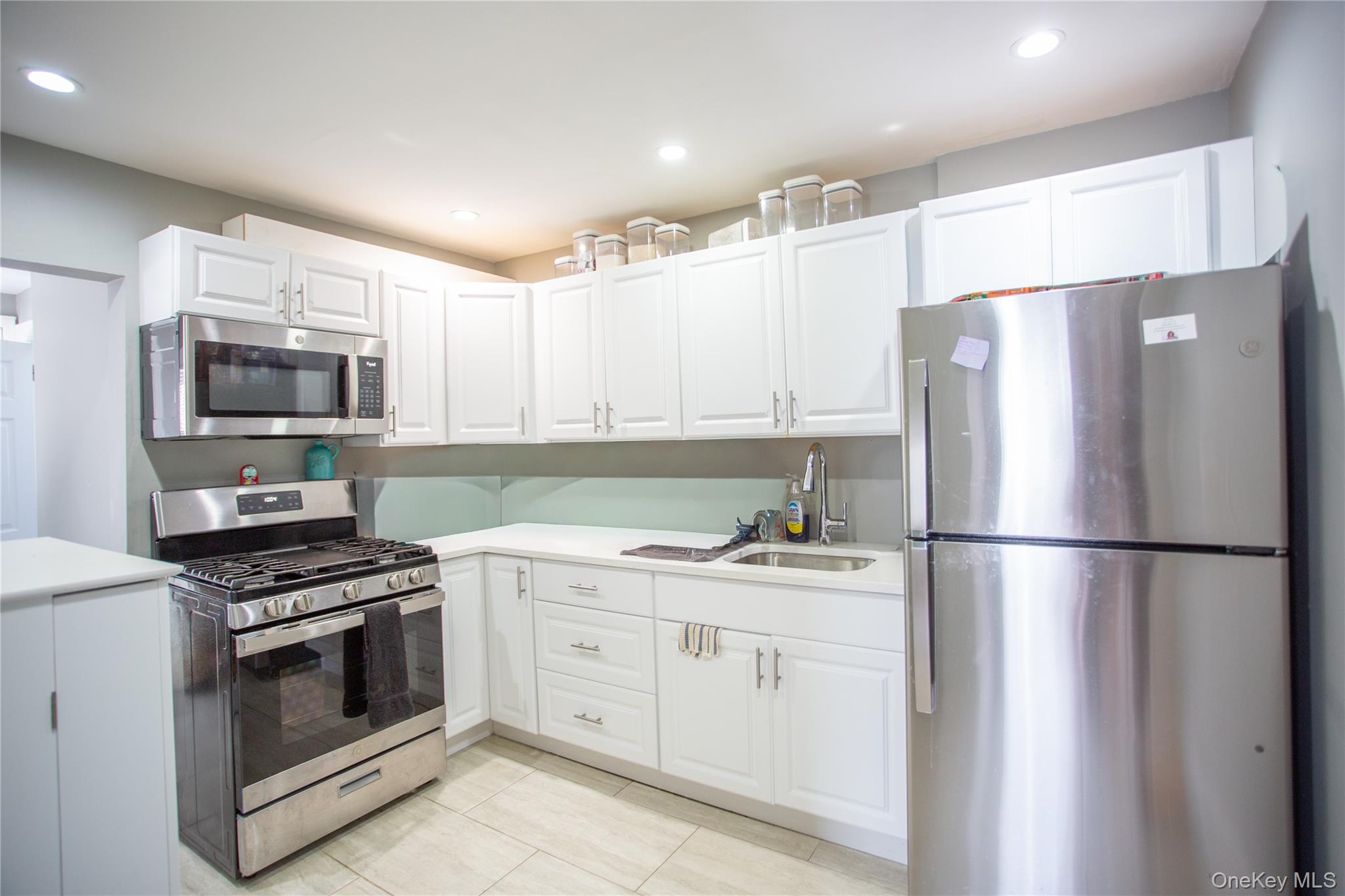 261 Rutland Road Freeport, NY 11520 - Photo 3 of 15 a kitchen with a refrigerator stove and microwave