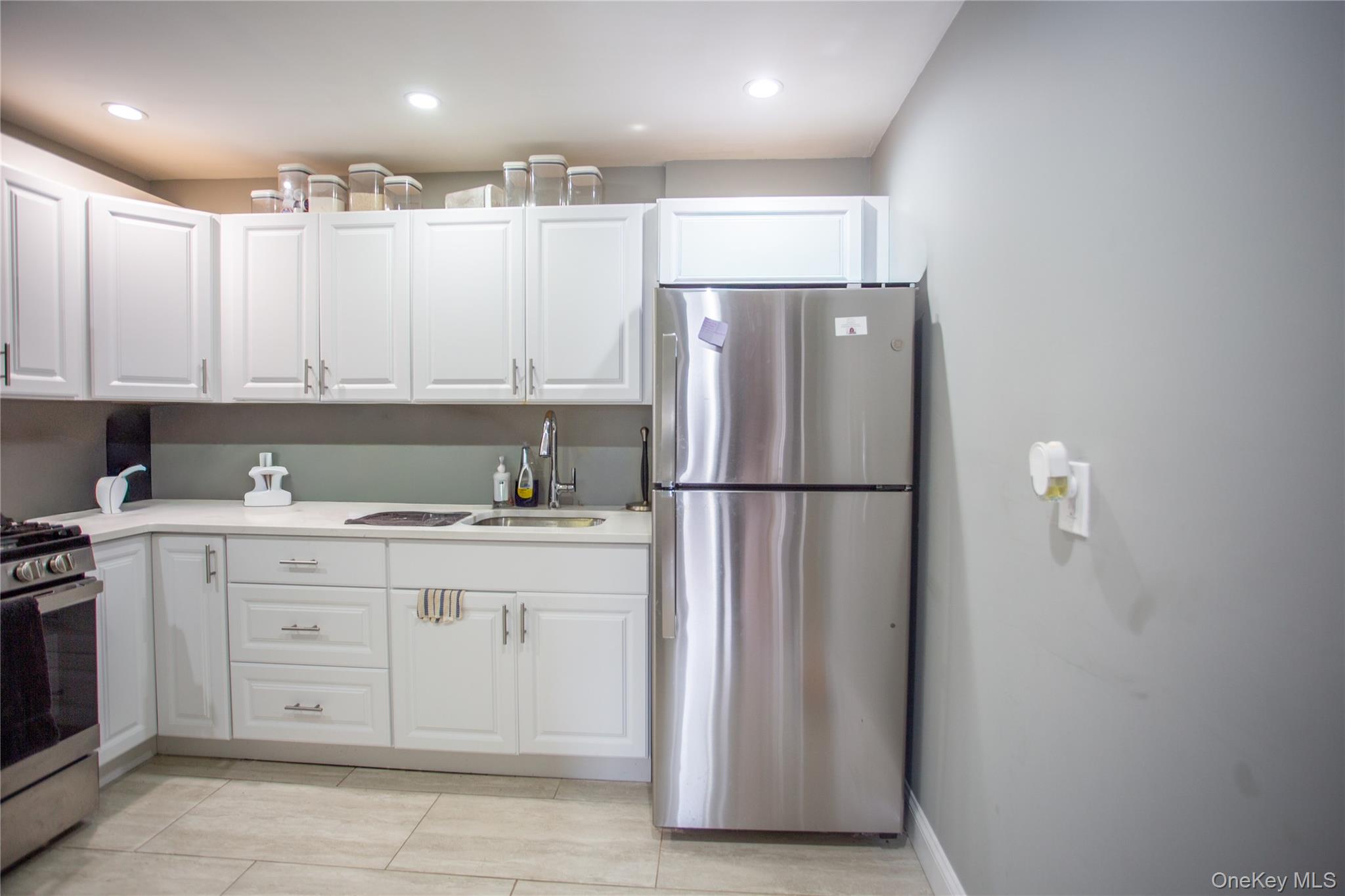 261 Rutland Road Freeport, NY 11520 - Photo 5 of 15 a kitchen with a refrigerator and a sink