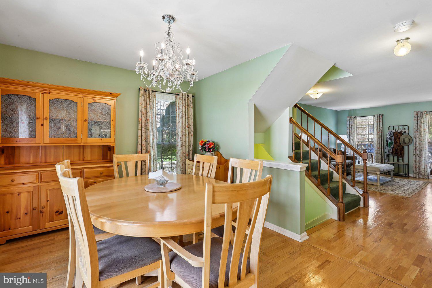 14822 Rose Trellis Place Silver Spring, MD 20906 - Photo 14 of 65 a view of a dining room with furniture and chandelier