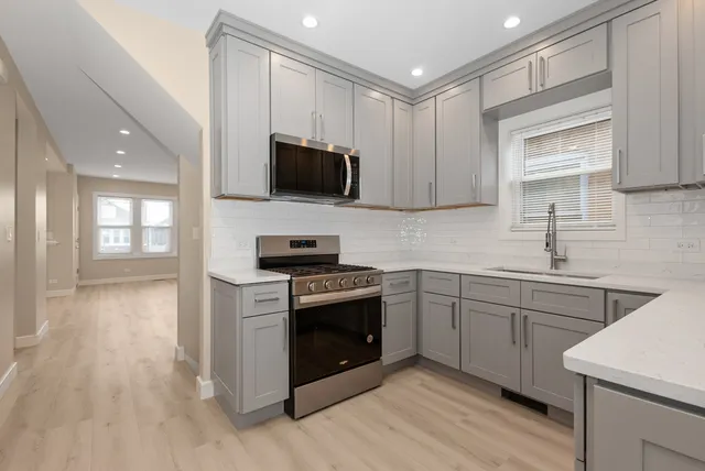 a kitchen with a sink stove and microwave