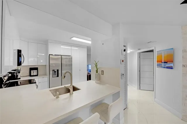 a kitchen with stainless steel appliances a refrigerator and a sink