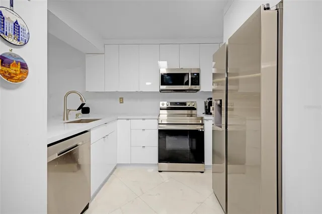 a kitchen with stainless steel appliances a stove a microwave and a refrigerator