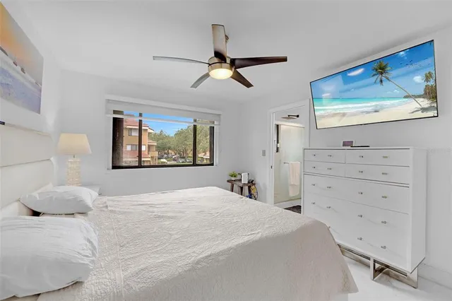 a bedroom with a bed and a painting on the wall